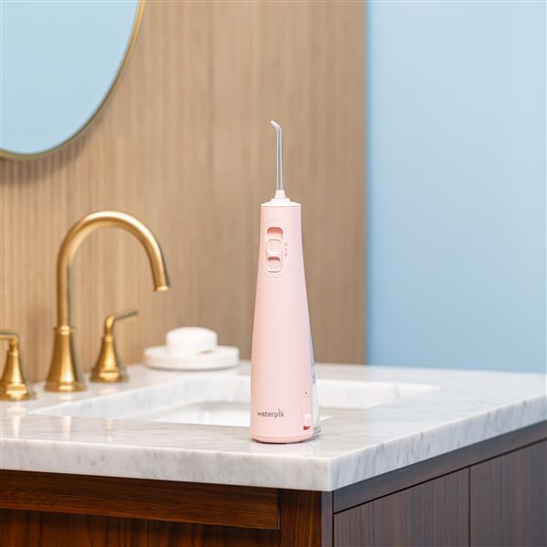 cordless-pulse-3100-water-flosser-wf-20cd014-pink-in-bathroom